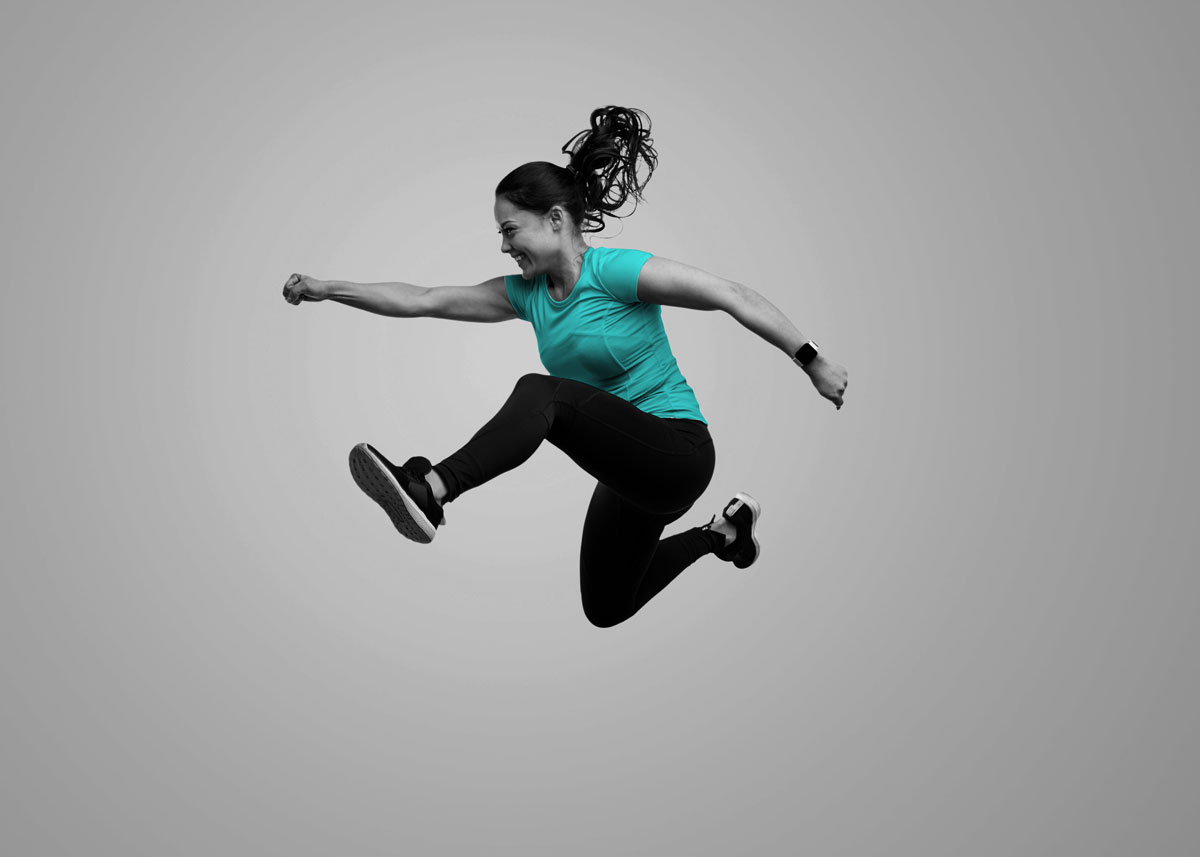 Female personal trainer jumping high